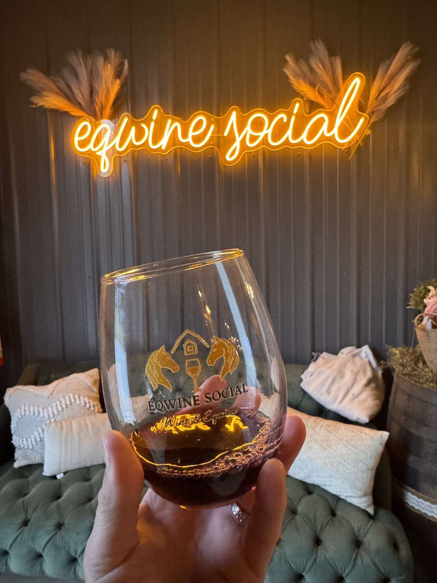 Eqwine Social neon sign above a signature wine glass
